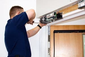 man installing a door