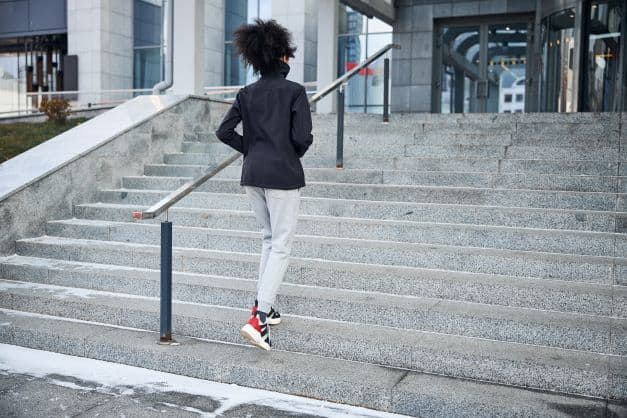 woman walking up to some automatic doors