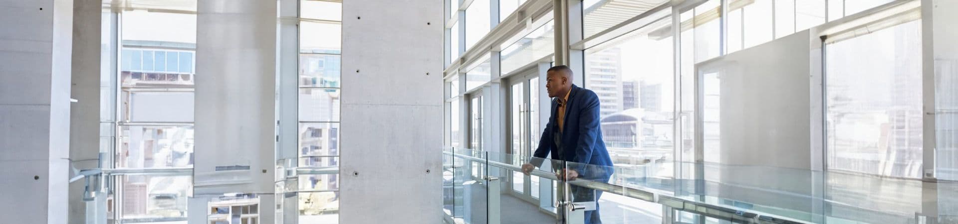 man in a glass building